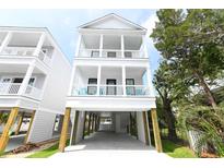 Two-story white house with a covered porch and attached garage at 115 A 11Th Ave. S, Surfside Beach, SC 29575