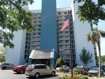 High rise building exterior, featuring blue and white color scheme and ample parking at 311 69Th Ave. N # 104, Myrtle Beach, SC 29572