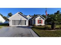 House exterior featuring a two-car garage and landscaping at 196 Marsh Hawk Dr., Myrtle Beach, SC 29588
