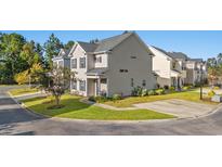 Two-story townhome with light beige siding and landscaping at 154 Terracina Circle, Myrtle Beach, SC 29588