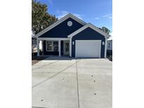 New construction home with navy blue siding, white trim, and a two-car garage at 1104 Seaside Dr., North Myrtle Beach, SC 29582