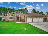 Brick house with three-car garage, green lawn, palm trees at 4746 National Dr., Myrtle Beach, SC 29579