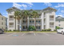 Attractive three-story building with palm trees and parking at 646 River Oak Dr. # 47-A, Myrtle Beach, SC 29579