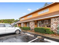 Exterior view of a yellow building with brick facade at 1830 Fairway Ridge Dr. # 6-F, Myrtle Beach, SC 29575