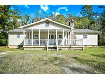 House exterior featuring a front porch and well-maintained lawn at 872 Jackson Circle, Conway, SC 29526