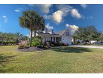 Beautiful two-story house with a manicured lawn and palm trees at 3403 Club Course Dr., North Myrtle Beach, SC 29582