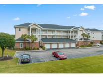 Two-story condo building with parking and green space at 4811 Orchid Way # 5-301, Myrtle Beach, SC 29577