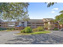 Exterior of building with landscaping and parking at 410 Melrose Pl. # 203, Myrtle Beach, SC 29572