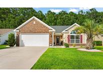 Brick house with two-car garage and lush lawn at 544 Running Deer Trail, Myrtle Beach, SC 29588