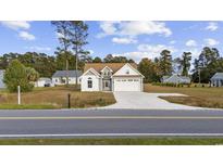 Charming two-story home with a paved driveway and attached garage at 1727 Cane Branch Rd., Loris, SC 29569