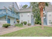 Light blue two-story building with stairs and balconies at 4337 Spa Dr. # 1309, Little River, SC 29566