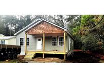 Newly built single-story home with a covered porch and wood accents at 135 Oak Log Lake Rd., Conway, SC 29526