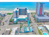 Aerial view of oceanfront resort with pool and parking at 1501 S Ocean Blvd. # 1038, Myrtle Beach, SC 29577
