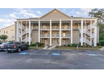 Two-story building with columns, balconies, and ample parking at 5810 Longwood Dr. # 201, Murrells Inlet, SC 29576