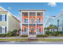 Two-story coral house with front porch and American flag at 1426 Peterson St., Myrtle Beach, SC 29577