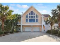 Two-story home with two-car garage and palm trees at 4607 Lewis Circle, North Myrtle Beach, SC 29582