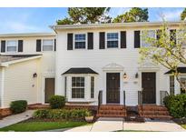 Two-story townhouse with white exterior and landscaping at 2925 Carriage Row Ln. # 134, Myrtle Beach, SC 29577