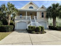 Two-story house with double garage, front porch, and landscaping at 101 Georges Bay Rd., Surfside Beach, SC 29575