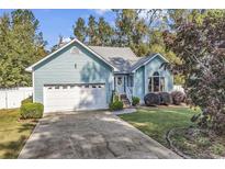 Charming light blue house with a spacious yard and driveway at 153 Garden Ave., Georgetown, SC 29440