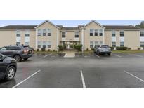 Building exterior, showing parking lot and landscaping at 8546 Hopkins Circle # G, Surfside Beach, SC 29575
