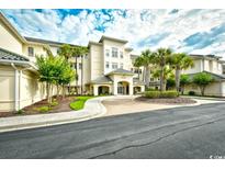 Exterior view of a light beige 3-story condo building at 2180 Waterview Dr. # 635, North Myrtle Beach, SC 29582