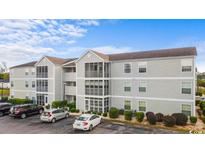 Two-story building exterior with parking lot and landscaping at 1980 F Bent Grass Dr. # F, Surfside Beach, SC 29575