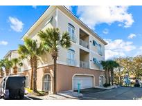 Three-story building with garage and palm trees at 304 76Th Ave. N # D, Myrtle Beach, SC 29572