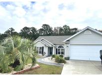 Charming single-story home with a landscaped front yard and attached two-car garage at 712 Pietras Ct., Murrells Inlet, SC 29576