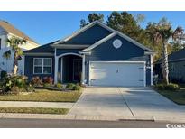 Beautiful blue exterior of a single-Gathering home with landscaping at 205 Juniata Loop, Little River, SC 29566