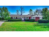Brick ranch house with a well-maintained lawn at 3701 South Green Sea Rd., Loris, SC 29569
