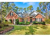 Brick home with a two-car garage and nicely landscaped yard at 4491 Horseshoe Bend, Murrells Inlet, SC 29576