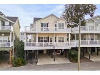Two-story beach home with elevated deck and parking underneath at 6001-G3 S Kings Hwy., Myrtle Beach, SC 29575
