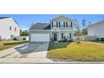 Two-story house with gray siding, white garage door, and landscaping at 438 Archer Ct., Conway, SC 29526