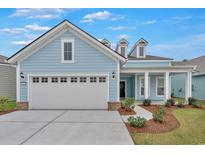 Two-story light blue house with a large gray garage door at 7274 Sarteano Dr., Myrtle Beach, SC 29572