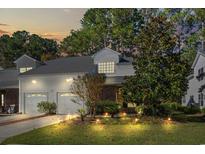 Brick townhouse with two-car garage and landscaped yard at night at 493 Shellbank Dr. # 2-B, Longs, SC 29568