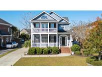 Two-story home with a wrap-around porch and manicured lawn at 879 Waterton Ave., Myrtle Beach, SC 29579