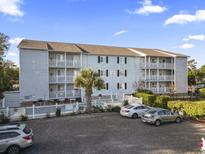 Condo building with pool and parking at 712 S Dogwood Dr. # 302, Surfside Beach, SC 29575