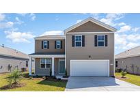Two-story home with a two-car garage and landscaped lawn at 510 Firouz Dr, Longs, SC 29568
