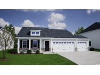 Two-story house with a two car garage, stone accents, and a landscaped lawn at 219 Sundrop Way, Conway, SC 29526