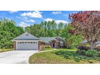 Brick ranch house with a two-car garage and landscaping at 4542 Mandi Ave., Little River, SC 29566