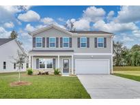 Two-story house with gray siding, white garage door, and landscaping at 320 Garden Grove St, Conway, SC 29526