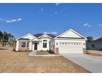 White house with brick accents and a two-car garage at 4959 Old State Highway 90, Conway, SC 29526