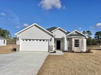 Charming new construction home with white siding, attached garage, and a landscaped front lawn at 4963 Old State Highway 90, Conway, SC 29526