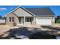 New construction home with gray siding, brick accents, and a two-car garage at 4967 Old State Highway 90, Conway, SC 29526