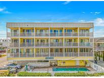 Three-story building with multiple balconies and a refreshing pool at 301 N Waccamaw Dr. # 211, Murrells Inlet, SC 29576