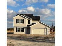 Two-story house with beige vinyl siding, a double garage, and a large front yard at 889 Busy Corner Rd., Conway, SC 29527