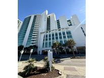 Oceanfront high-rise building with palm trees and ample parking at 201 S Ocean Blvd. # 714, Myrtle Beach, SC 29577