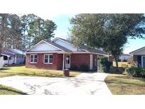 Brick ranch home with red shutters, driveway, and landscaping at 425 Spauldingwood Rd., Little River, SC 29566