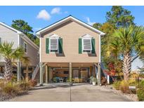 Charming raised beach cottage with spacious driveway and a covered patio at 4315 Grande Harbour Blvd., Little River, SC 29566