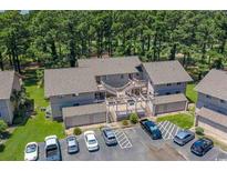 Aerial view of a condo community with a pool, parking, and lush landscaping at 3015 Old Bryan Dr. # 17-7, Myrtle Beach, SC 29577